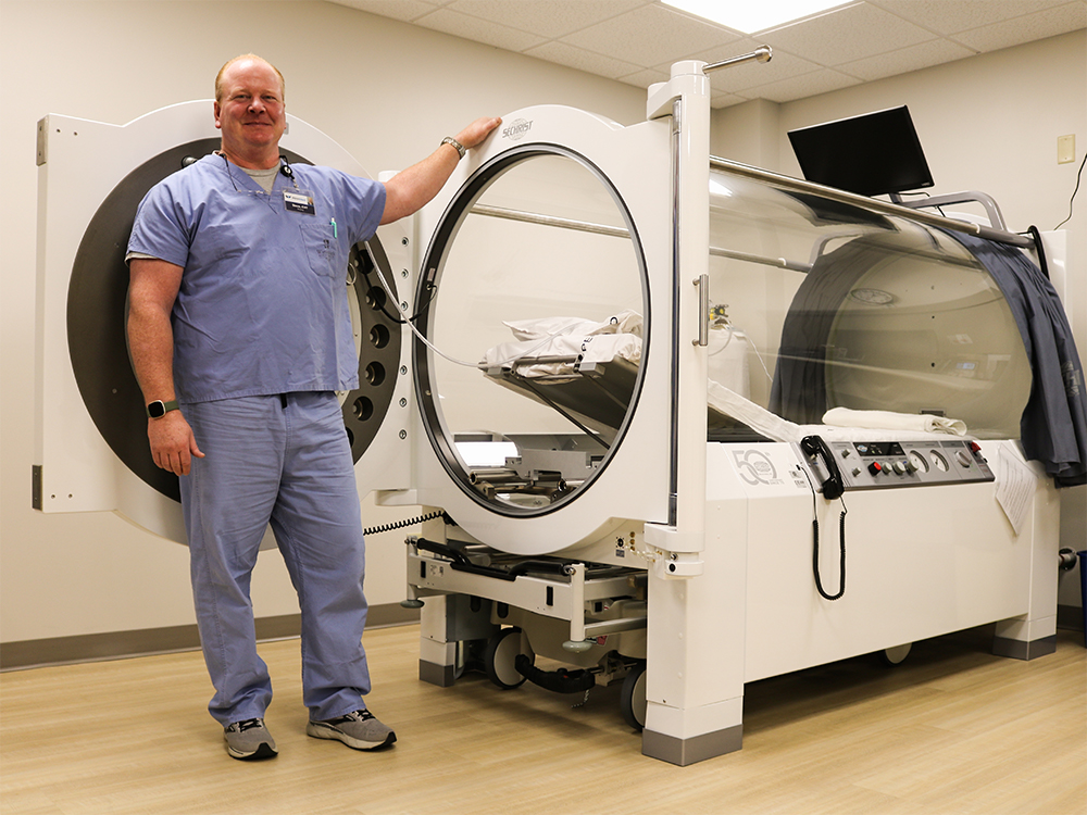 Steve Mayer, HBO Tech, stands next to the new hyperbaric oxygen chamber at WinnMed.