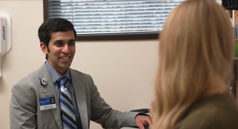 Dr. D'Netto discussing allergy care with a patient