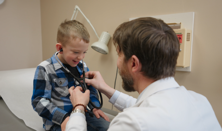 Dr. Menke listening to a patient's heart