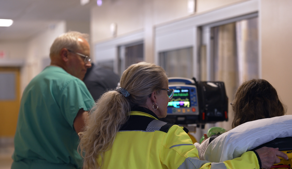 Pushing a patient down the hall in the emergency room