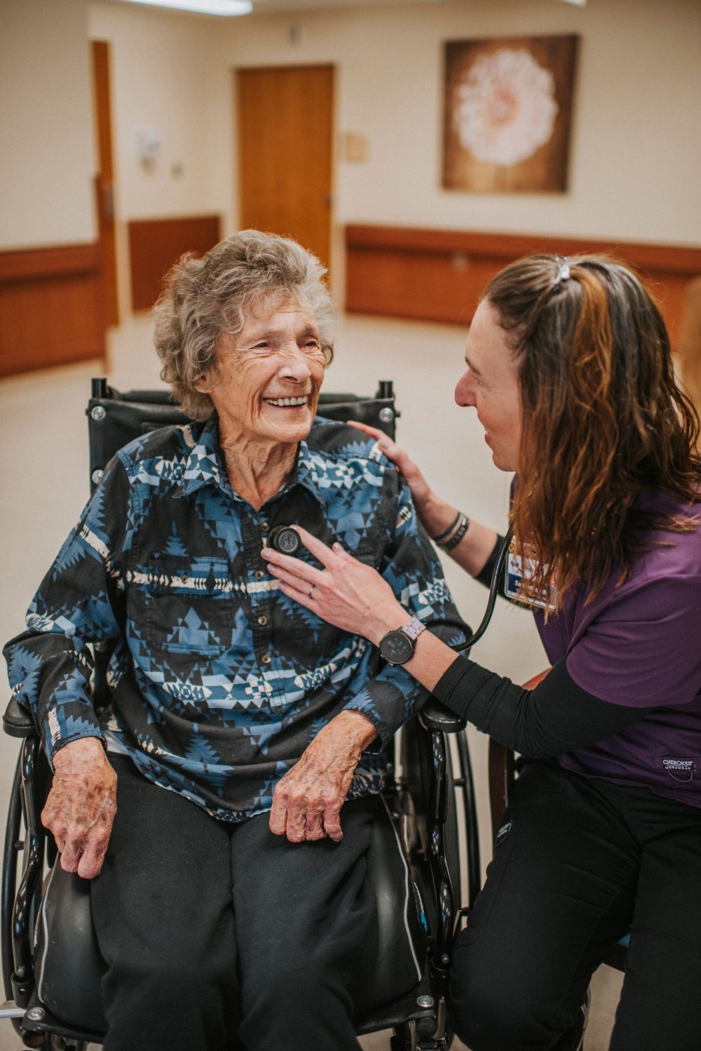 Hospice nurse listening to a patient's heart