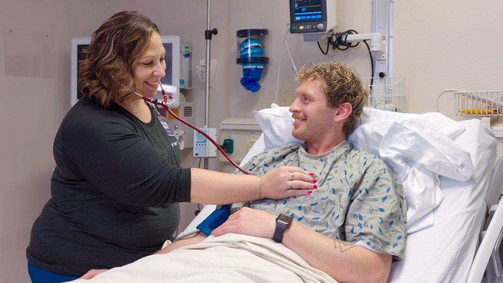 Med/surg nurse listening to a patient's heart