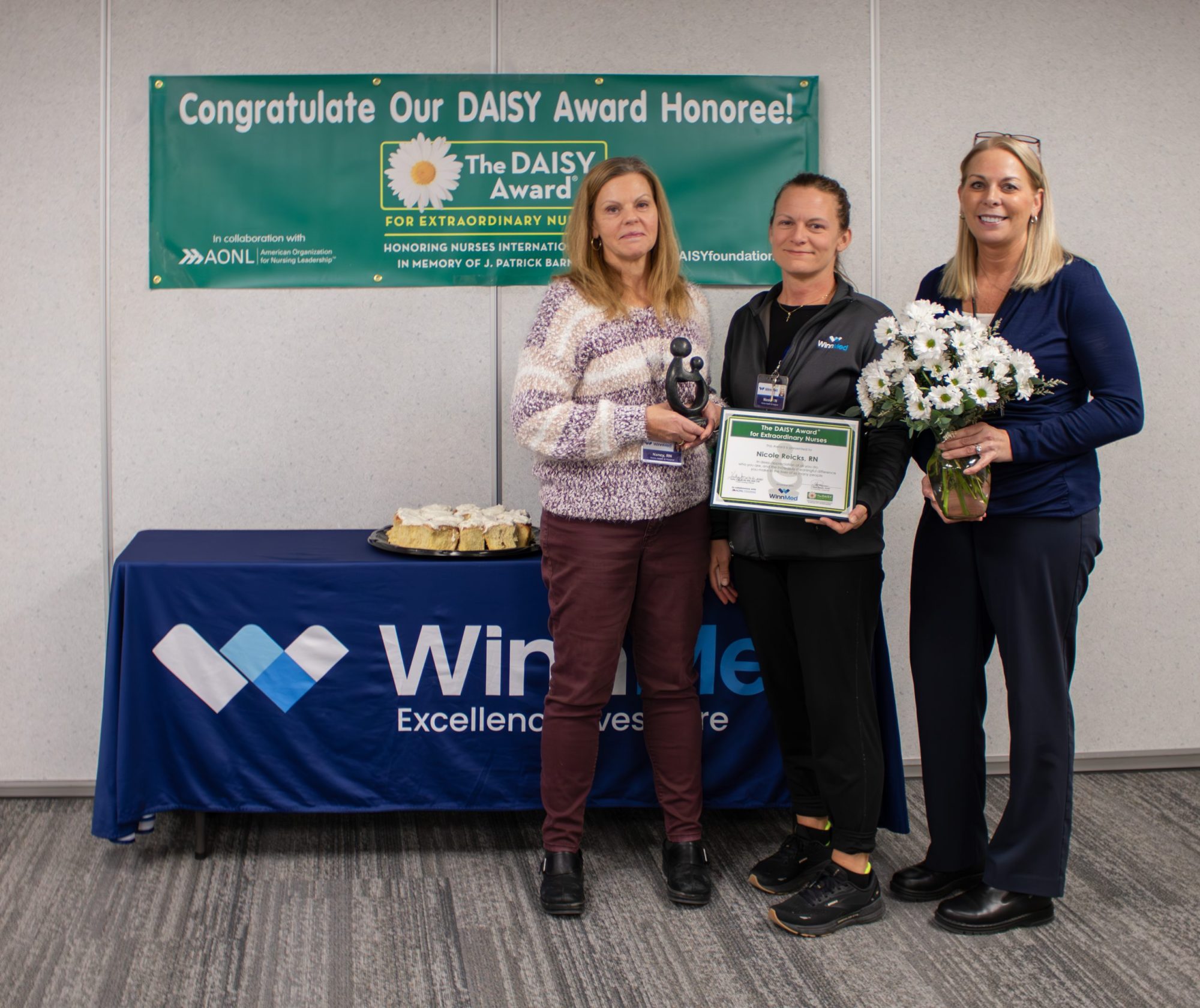 WinnMed Registered Nurse Nicole Reicks recently received the DAISY Award. Nicole (center) is pictured with WinnMed nursing leaders Nancy Haberichter, director of Home Health and Hospice (left) and Kathy Moritz, chief nursing officer (right).