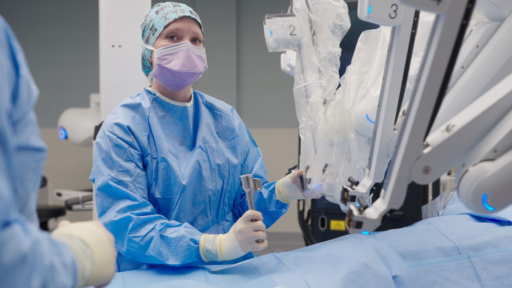 Surgical Technologist prepares the robot for surgery.