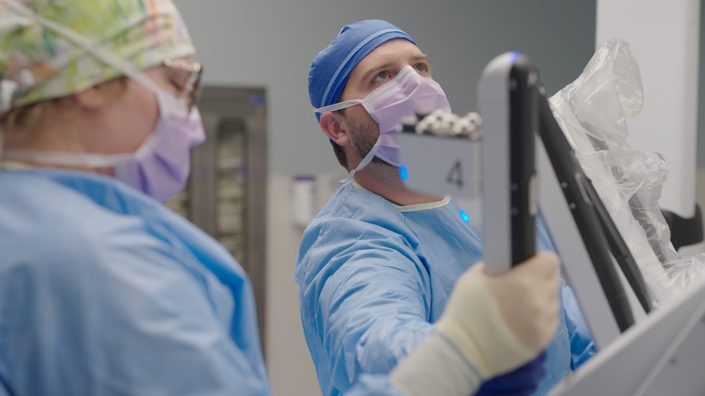 Dr. Winters, Emplify Health by Gundersen General Surgeon, assists with the robotic system.